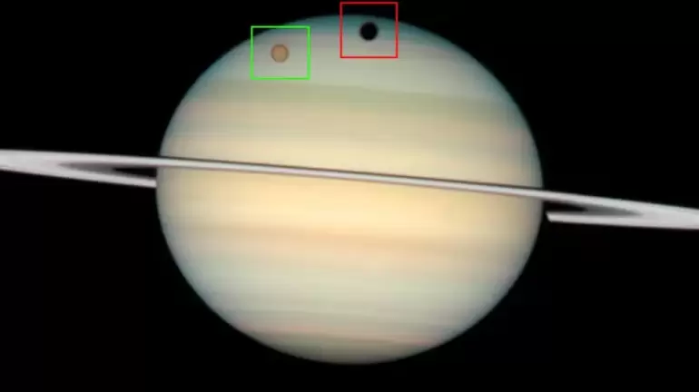 Titn y su sombra proyectada sobre Saturno. (Imagen NASA-JPL)